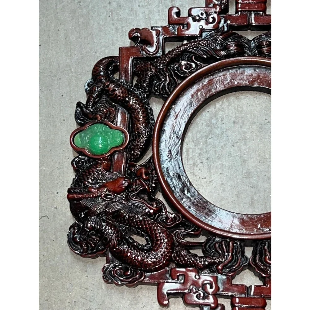 Chinese good luck wall hanging featuring a carved dragon design red knot tassel.